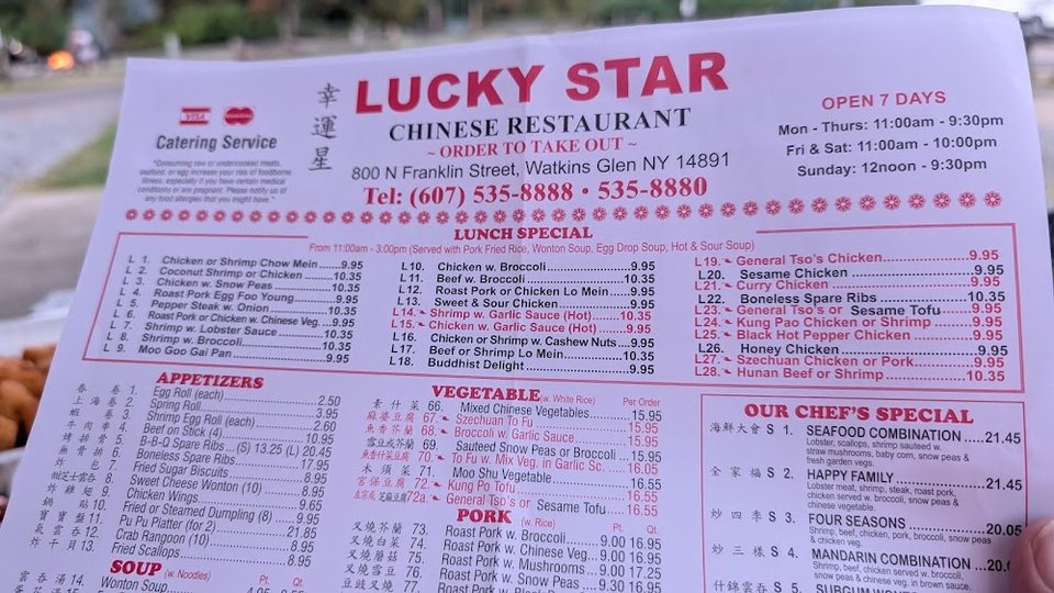Printed menu beside a restaurant counter.